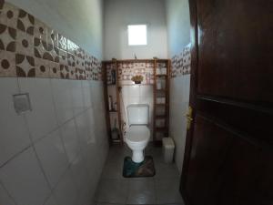 a bathroom with a toilet in a small room at Le tournesol Belle villa in Maroantsetra Airport +13 photos