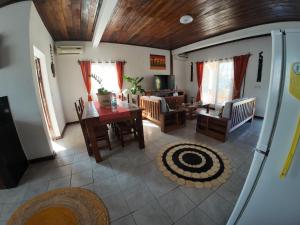 a living room with a table and a dining room at Le tournesol Belle villa in Maroantsetra Airport