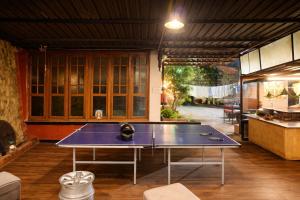 a ping pong table in the middle of a room at Secret Escape Colonial Bungalow in Ooty