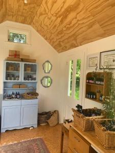 a room with a blue cabinet with baskets on it at Quail Farm, Colonial charm in Nelson