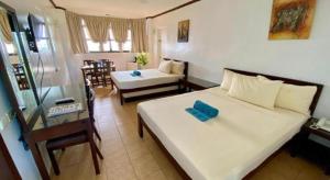 a hotel room with a bed and a desk and a room at Lago de Oro in Balibago +119 photos