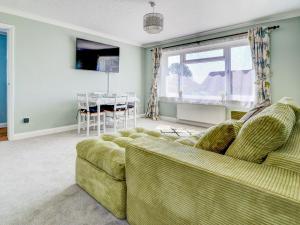 a living room with a couch and a table at Dorset Escape in Gillingham