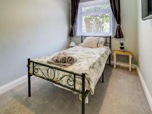 a bedroom with a bed in a room with a window at Dorset Escape in Gillingham +6 photos
