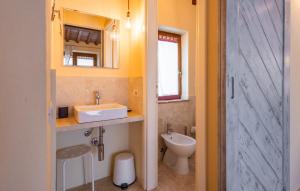 a bathroom with a sink and a toilet and a mirror at La Casina dei Lapi in Catabbio +2 photos