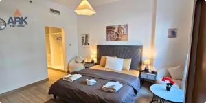 a bedroom with a bed with towels on it at Ark Living Stay in Yas Island in Yas Island +113 photos