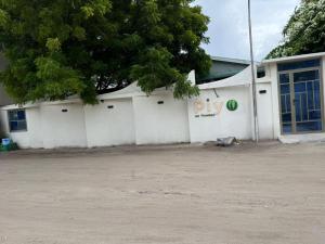 a white building with a dip sign on it at Piyo in Thoddoo