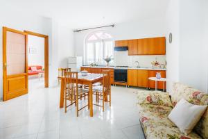 a kitchen and living room with a table and chairs at Casa al Belvedere in Vico Equense