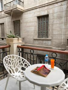 a white table and chairs on a balcony at The Grand Elite Cairo Hotel in Cairo