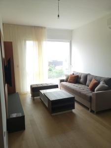 a living room with a couch and a coffee table at AH Home Delux Centar in Sarajevo