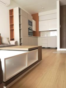 a kitchen with white cabinets and a counter top at AH Home Delux Centar in Sarajevo