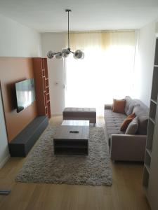 a living room with a couch and a coffee table at AH Home Delux Centar in Sarajevo +3 photos