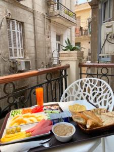 a table with a tray of food on a balcony at The Grand Elite Cairo Hotel in Cairo