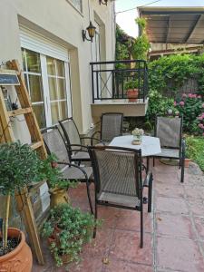 a group of chairs and a table on a patio at Spring Harmony Trikala Pigi in Tríkala