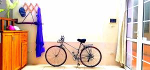 a bike parked in a room next to a window at GuInn in Hanoi