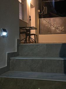 a set of stairs leading to a table and a tableablish at Villa Kazani by Karda Suites in Chios +2 photos