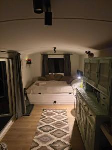 a bedroom with a large bed in a room at Tiny House Zagroda Kopytkowo in Ropica Górna