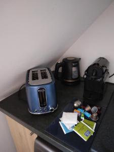 a counter with a toaster and a coffee maker on it at Ab gite et spa in Benfeld