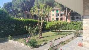 a garden with trees and flowers in front of a building at A due passi dal mare in Portovenere