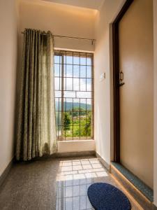 a room with a large window with a view at White Lily in Guwahati