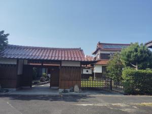 a house with a gate and a fence at MEKIKI出雲 izumo in Izumo +3 photos