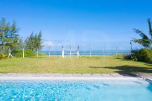 a swimming pool with a view of the ocean at Le Bergamote in Riambel
