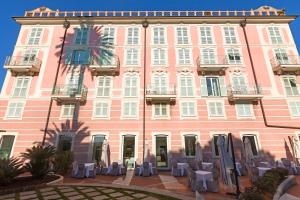 a large building with a clock on the front of it at Europa Hotel Design Spa 1877 in Rapallo