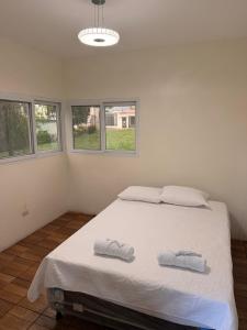 a bedroom with a bed with two towels on it at Dormilón in San Felipe