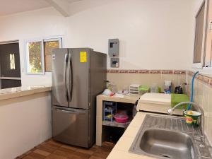a kitchen with a stainless steel refrigerator and a sink at Dormilón in San Felipe