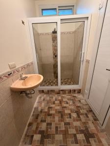 a bathroom with a shower and a sink at Dormilón in San Felipe +2 photos