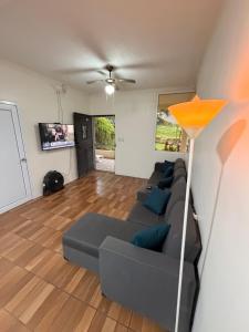 a living room with a couch and a lamp at Dormilón in San Felipe