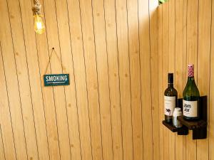 two bottles of wine on a wooden wall at Leo's Cozy Cabin in Ella +17 photos