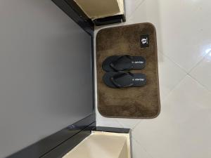 a pair of black sandals sitting in a box at Ngara Sleasure in Songea