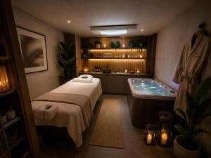 a bathroom with a bed and a bath tub at Palms Resort in Hampreston