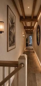 a hallway with a staircase with a painting on the wall at Palms Resort in Hampreston