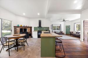 a kitchen and living room with a table and chairs at Jam Cottage Tolmie in Tolmie