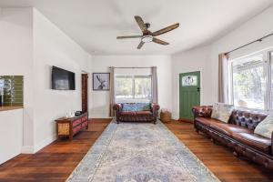 a living room with a couch and a ceiling fan at Jam Cottage Tolmie in Tolmie