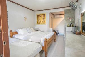 a bedroom with two beds and a hallway at The Houme - Fisherman Village in Bophut