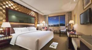 a hotel room with a large bed and a television at Lhasa Hotel in Lhasa