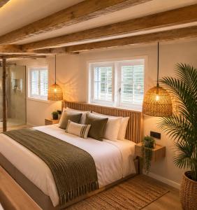 a bedroom with a large bed and two windows at Palms Resort in Hampreston