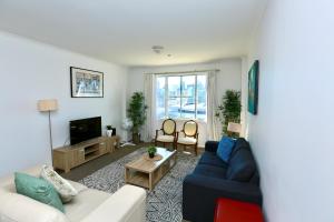 a living room with a couch and a tv at Goldsbrough 2 bedrooms split apartment in Sydney