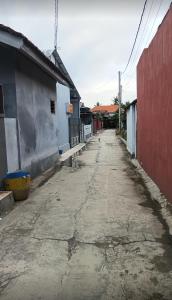 an empty street in a town with a red building at DMP Homestay in Ketapang