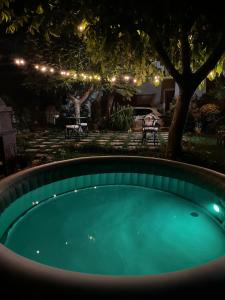 a swimming pool in a backyard at night with lights at HedèraRooms in Agerola