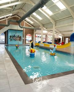 a indoor swimming pool with ducks in the water at 8 berth 3 Bedroomed CARAVAN Lyons Robin Hood Rhyl 17 Elm Crescent in Meliden