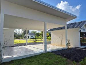 a large white house with a patio at NS Khaolak Resort in Khao Lak