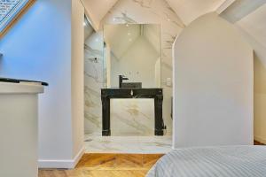 a fireplace in a room with a marble wall at Exceptional double house with Jacuzzi in Lille +44 photos