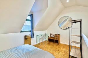 a bedroom with a bed and a mirror at Exceptional double house with Jacuzzi in Lille