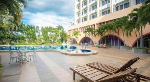 a resort with a swimming pool and a building at Wangtai Hotel in Suratthani