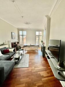 a living room with a couch and a table at La Perle de Toulon, grand appartement tout confort, idéalement situé in Toulon +33 photos
