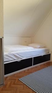 a bed in a room with a white mattress at Grevelingen 24 Ouddorp in Ouddorp