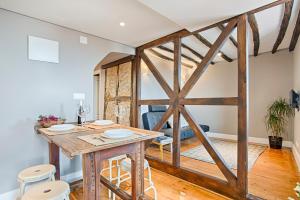 a barn door in a living room with a table and stools at River View Alfama Historic Lisbon in Lisbon